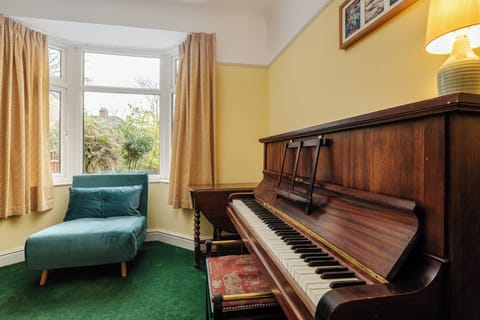Discover a charming sitting room with an acoustic upright piano—a rare find for music lovers. Relax on the small sofa bed with all bedding provided, or browse the books displayed in the elegant cabinets for a nice evening in.
Fireplace NOT in use.