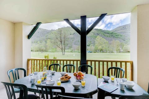 Private balcony with outdoor dining and panoramic views of the Pyrenees — enjoy breakfast or evening drinks surrounded by nature.