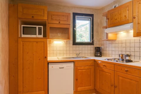 Fully equipped kitchenette with microwave, dishwasher, and electric hobs