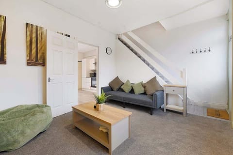 Bright open-plan living area featuring a comfortable sofa and a Smart TV, creating the perfect space to relax, unwind, or enjoy your favourite shows after a day of exploring.