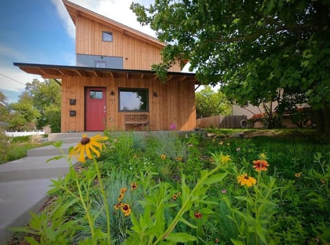 Charming cabin retreat surrounded by vibrant wildflowers and greenery