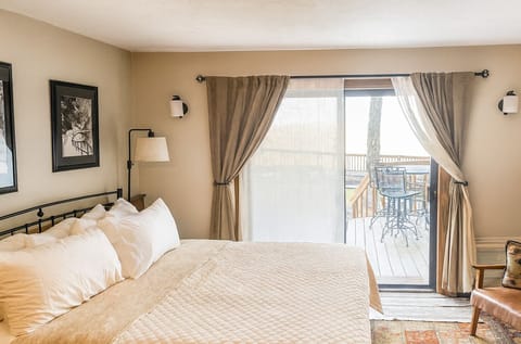 King bed with private slopeside deck entrance.