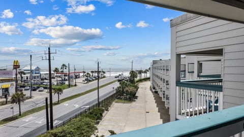 Private 3rd-floor balcony view at Condo 335—enjoy coastal breezes and a lively glimpse of Galveston Seawall
