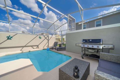 Enjoy a private pool area with lounge chairs and a barbecue grill under a screened enclosure.