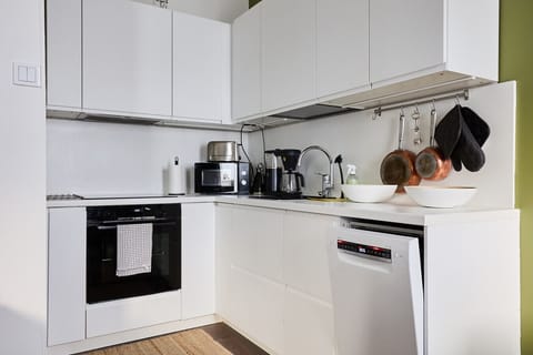 Your kitchen area provides everything needed for light cooking—note the integrated dishwasher for stress-free cleanup, along with a toaster and coffee maker.