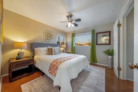 MAIN HOUSE: Bright and comfortable Bedroom 2 with queen bed, closet, ceiling fan, and stylish, cozy décor