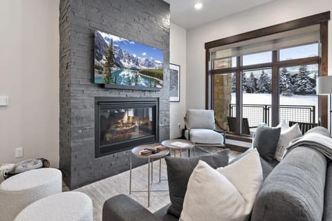 The living area windows provide the home with plenty of natural light and views of the golf course.