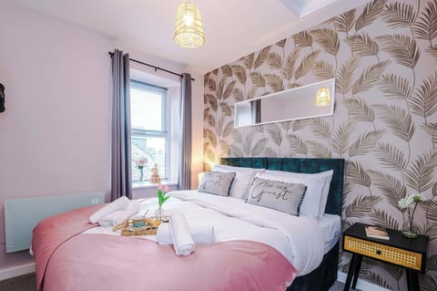 Peaceful bedroom with plush bedding and soft lighting – perfect for a restful night’s sleep.