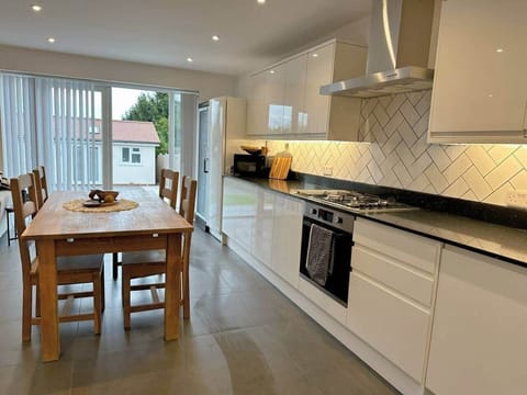 Open plan kitchen with dining table