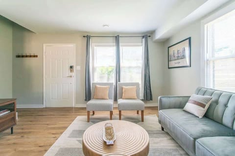 Living Room: Sunlit space with chic seating and modern decor, perfect for relaxation and gathering! 