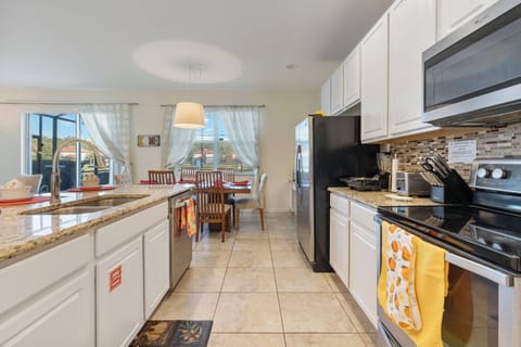 Bright and airy, this kitchen features white cabinetry and a stunning granite countertop, perfect for meal prep. The open layout seamlessly connects to the dining area, inviting you to gather around the table with loved ones.