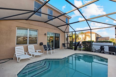 Step outside to your private oasis featuring a sparkling pool and comfy lounge chairs. The screened enclosure offers stunning sky views while keeping insects away, ideal for your relaxing afternoons.
