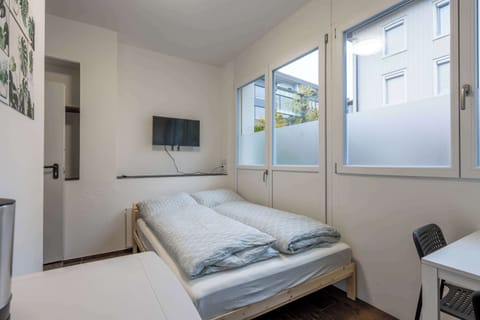 Bright double room with large windows and natural light
