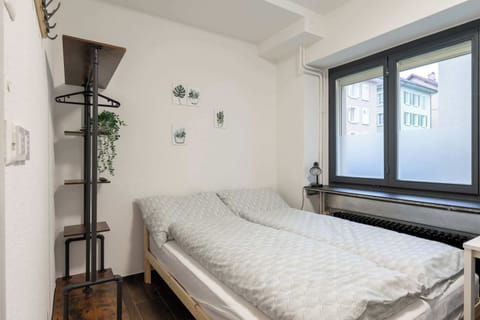 Cozy double room with comfortable bed and large window
