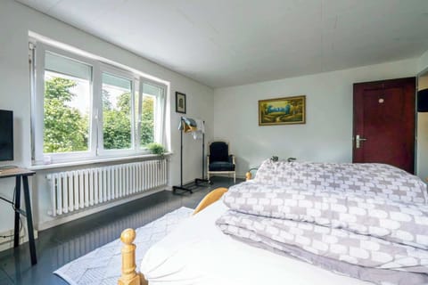Bright king bedroom with large windows and natural light