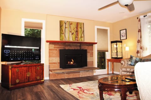 Welcome to upstairs living room. Gas fireplace with blue marbles. New QLED TV. 