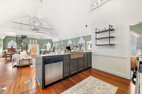 Spacious, bright kitchen: modern stainless steel appliances and large island.