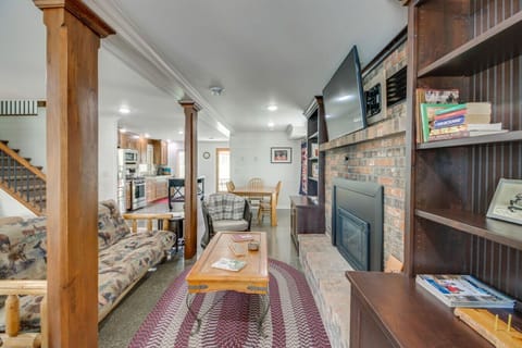 Rustic living room | Features wood accents, cozy seating, brick fireplace, and built-in shelving