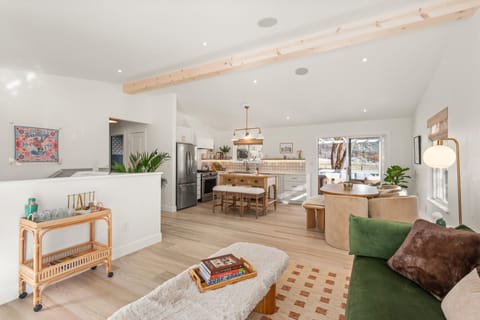 Bright open-concept living, dining, kitchen with mountain views.