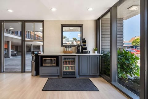 Small refreshment area with microwave and glass-front fridge