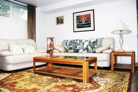 Downstairs living room with genuine soft leather couches. Thick comfy wool rug