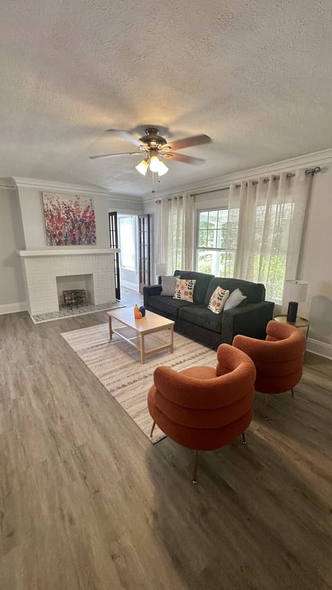 Bright and spacious living room with a decorative fireplace, Smart TV, and comfortable seating—perfect for relaxing after a day exploring Cleveland.