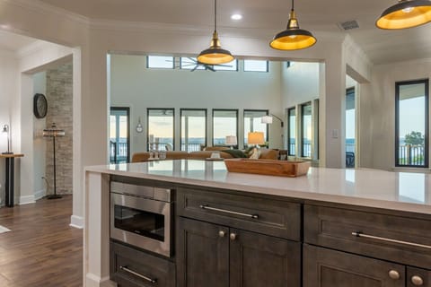 Island + bar seating opens to living room