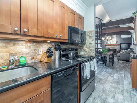 Kitchen flows directly back into gathering area.  Large granite counter top.