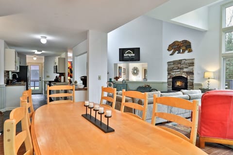 Large dining table seats eight comfortably. Perfect for game nights or family meals with a forest view.