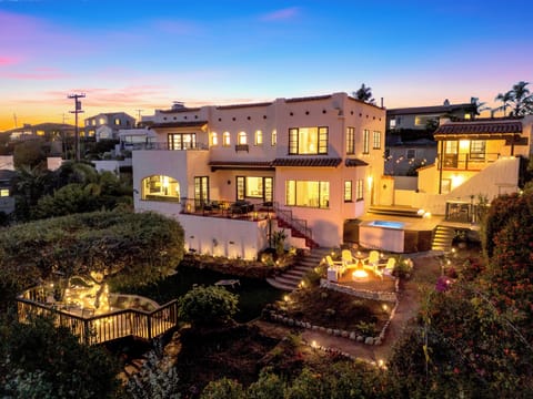 Your dream getaway begins here! A stunning Spanish-style home glowing at sunset!