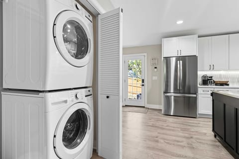 The hidden washer and dryer make longer stays easy, tucked neatly off the kitchen for convenience.