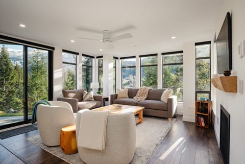 Living Room - Open concept with warm and natural tones, gas fireplace and stunning mountain views