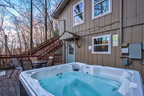 Soak in your private hot tub while surrounded by peaceful woods, creating the perfect outdoor retreat for relaxation.