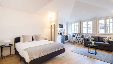 A bright and stylish open-plan studio with elegant decor, modern furnishings, and large windows offering abundant natural light. #LovelyStay #StudioLiving #ShortTermRental