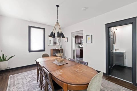 Open-concept dining and living area with stylish lighting and comfortable seating.