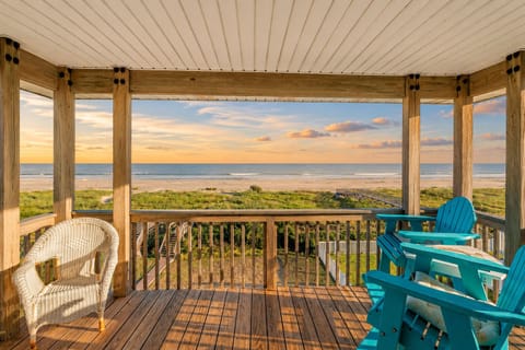 Covered beachfront balcony with stunning ocean views, outdoor seating, and relaxing coastal breeze in Galveston vacation rental