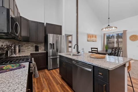 Kitchen w/ modern appliances, generous counters, & easy flow to living areas.