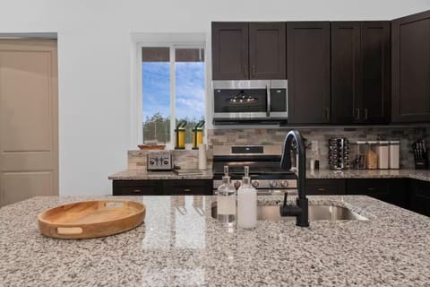 Kitchen w/ modern appliances, generous counters, & easy flow to living areas.