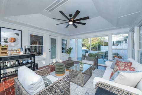 Relax in this bright, breezy sunroom overlooking the pool, where comfortable seating and a nearby coffee and tea bar make it the perfect spot to gather, sip, and enjoy slow, peaceful moments.
