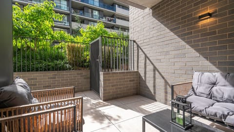Sunlit courtyard corner with comfortable outdoor seating.
