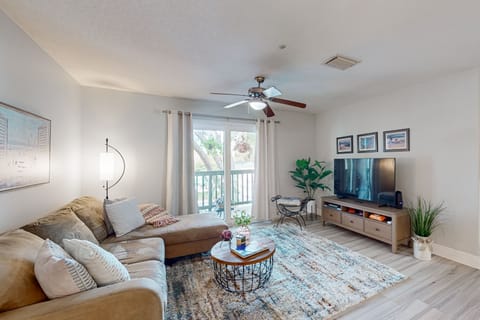 Bright & airy living room with sliding glass doors that lead to private patio