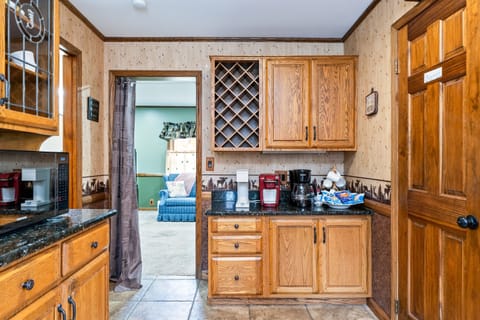 Spacious kitchen with oak cabinetry and a built-in wine rack—perfect for entertaining or enjoying a cozy night in