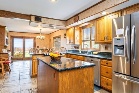 Fully equipped kitchen with stainless appliances and island bar — perfect for group meals and easy entertaining.