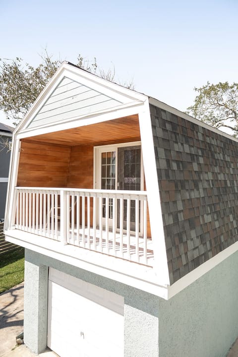 Warm wood accents and open views make this porch inviting and cozy.