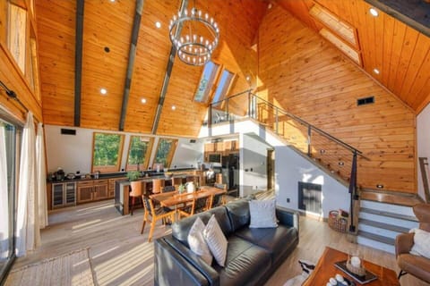 Step into a sun-drenched, open-concept living room where natural light pours through expansive windows, offering nice views and an airy, spacious feel.