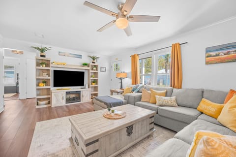 Bright and spacious living room designed for comfort and connection. Relax on a cozy sectional, enjoy movie nights on the large TV, or gather with family and friends in this inviting open-concept space after a day of exploring