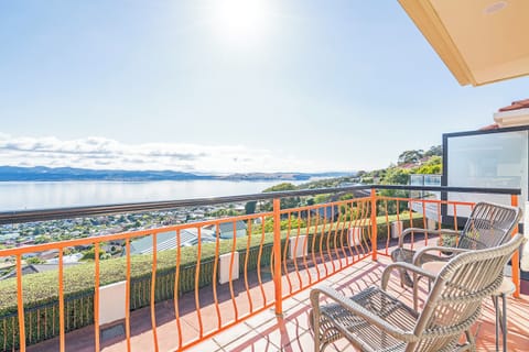 Start the day slowly on the sun-drenched balcony, where morning coffee comes with sweeping Derwent River views from high above Sandy Bay.