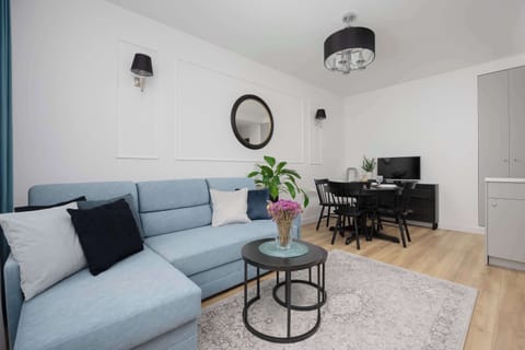 The image shows a bright relaxation area with a blue sofa that offers a comfortable spot to unwind after a full day.