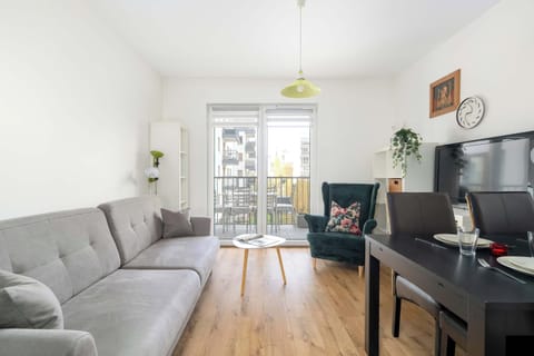 Bright and cozy living room with comfortable sofa and access to the balcony.