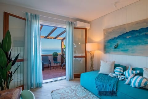 Deluxe Apartment, Sea View | Living area | Flat-screen TV